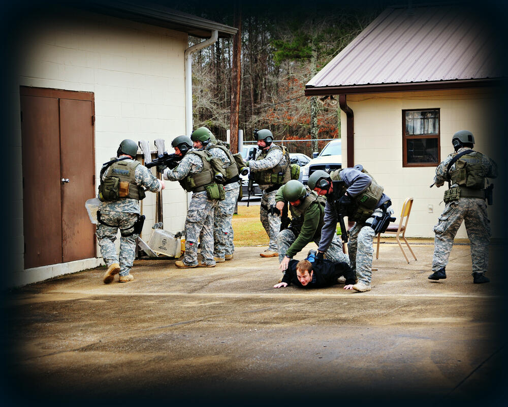 Joint Special Operations Group detaining suspect