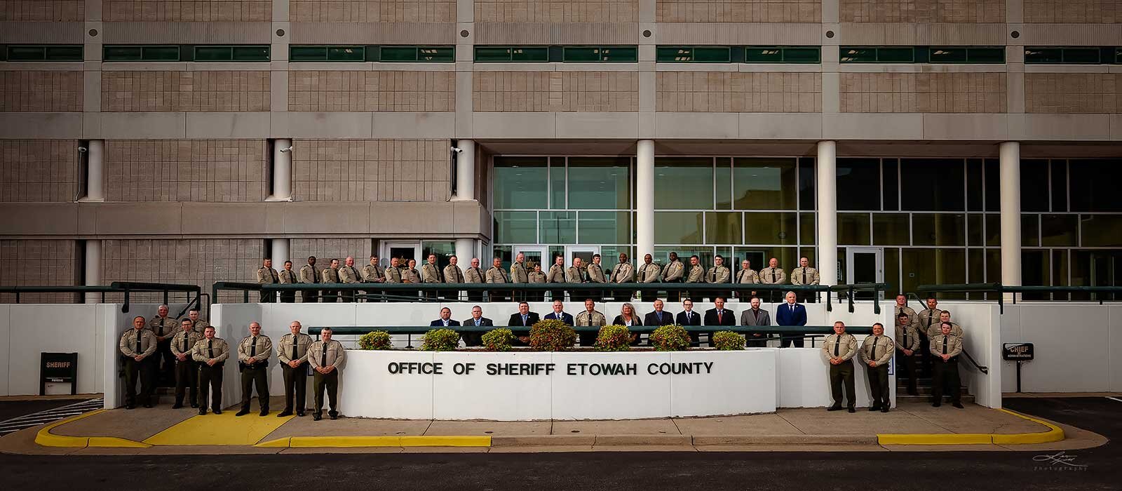 Sheriff and Deputies standing in front of Sheriff's Office building